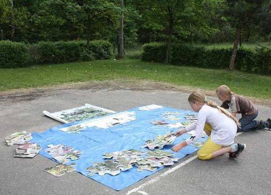 Uczniowie SP Kłodawa podczas układania puzzli  grafika